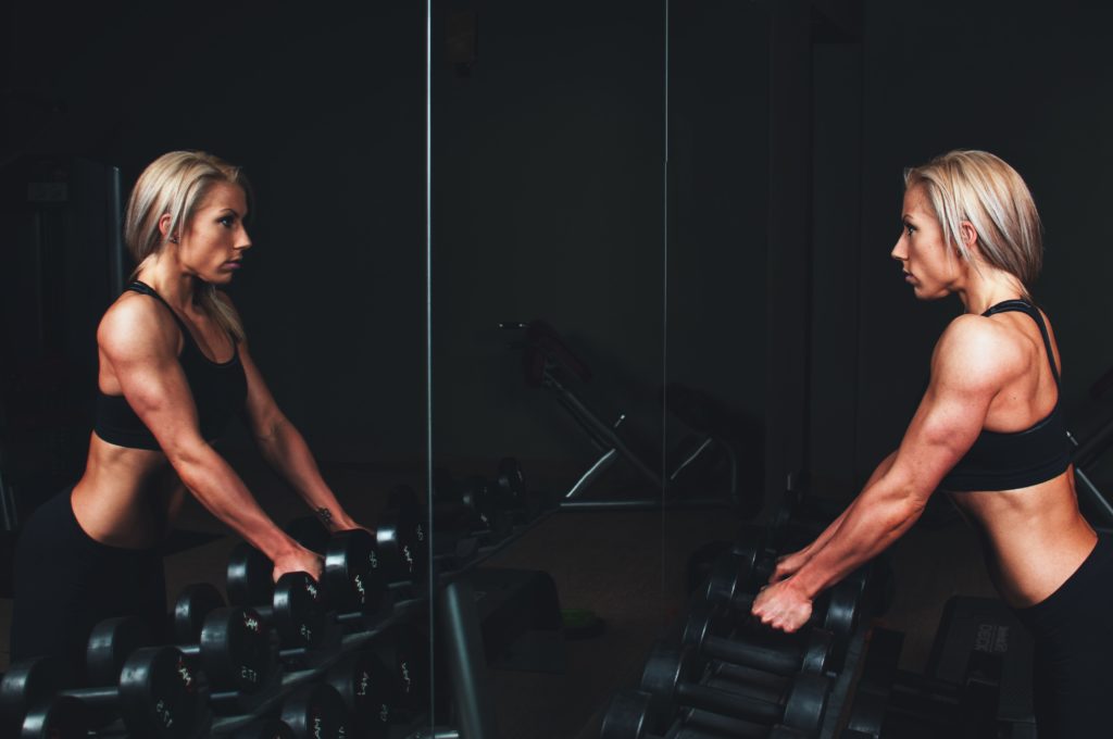 Woman at a gym building a weight loss mindset