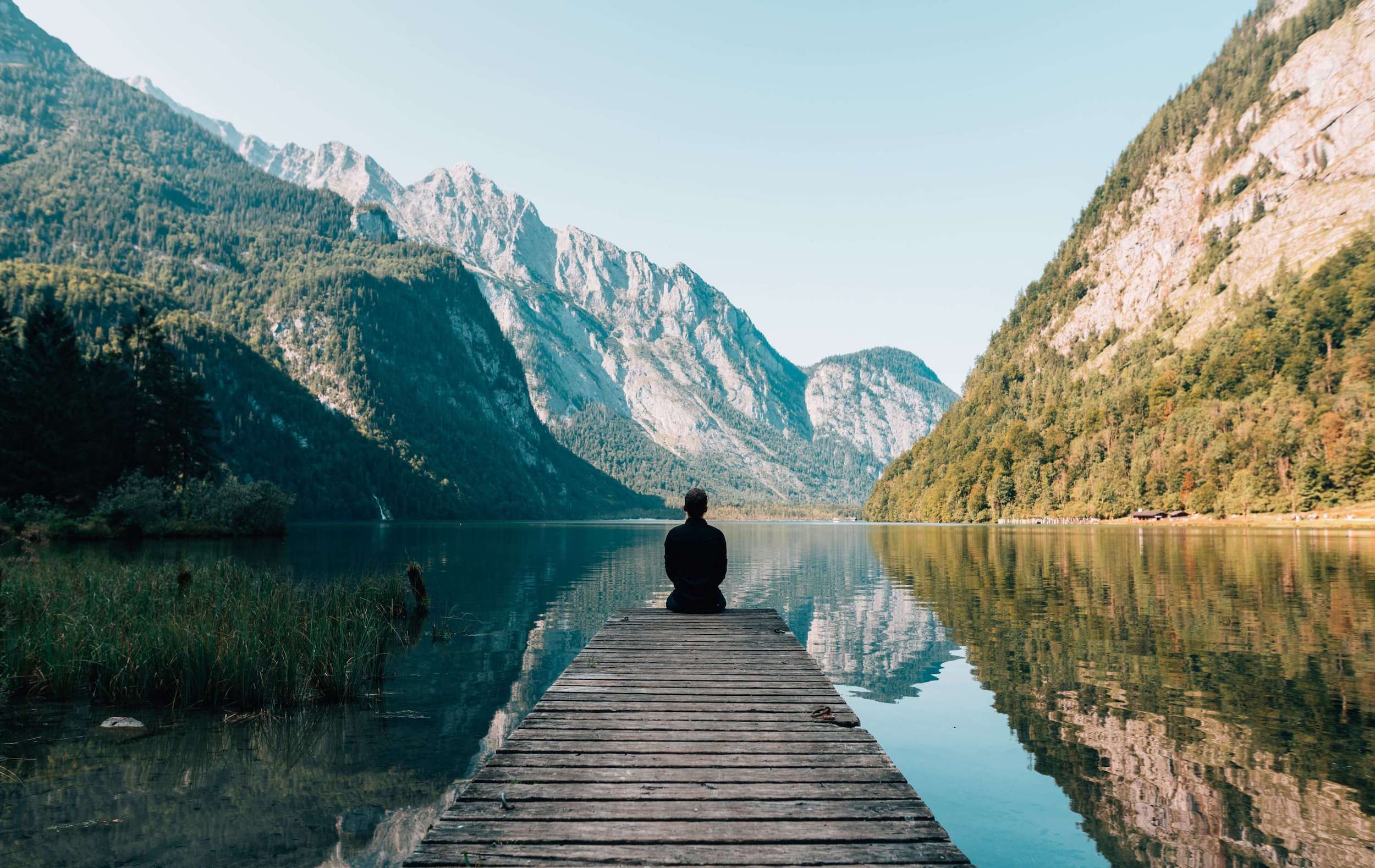 man on edge of lake practicing mindfulness for beginners