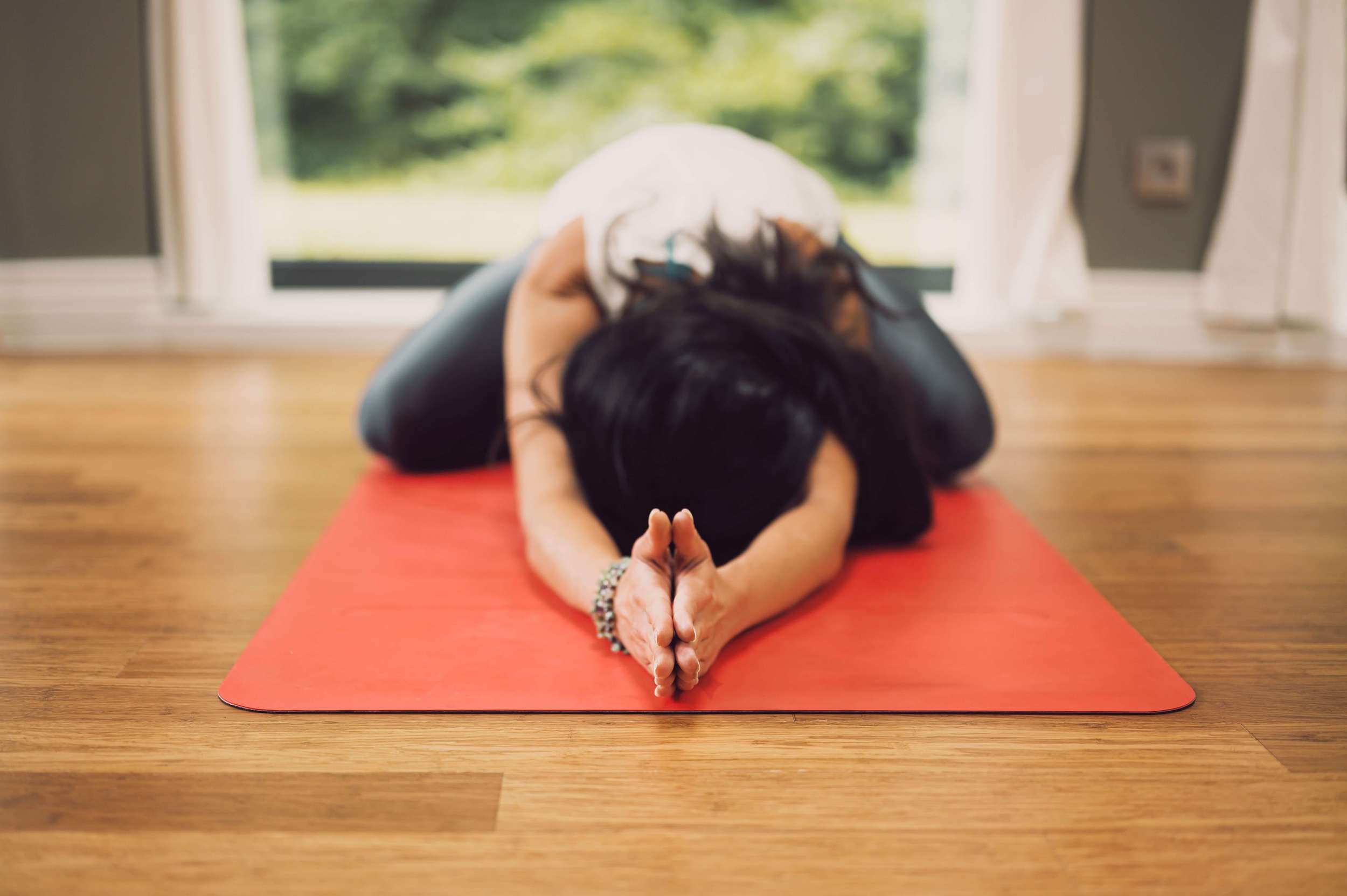 Woman doing morning stretches to commit to a wellness routine